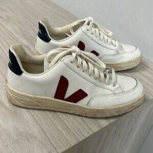 White vejas with red v and navy heel